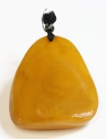 Lot 328 - A free-form butterscotch amber pendant