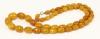 Lot 329 - A single row graduated amber bead necklace