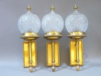 Lot 772A - Three modern brass wall lights with glass shades