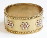 Lot 277 - A Victorian coral and split pearl gold hinged bangle