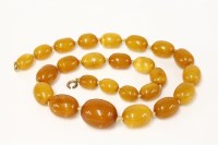 Lot 326 - A single row graduated amber bead necklace