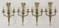 Lot 452 - A set of four gilt bronze twin branch wall lights