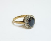 Lot 11 - A 9ct gold oval sapphire and diamond cluster ring