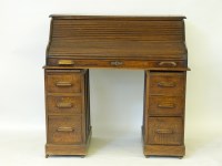 Lot 542 - A 1920s oak roll top desk