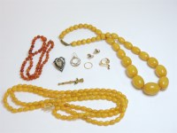 Lot 64 - A graduated row of small amber beads