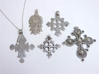 Lot 49 - A collection of one silver and four white metal Coptic crosses