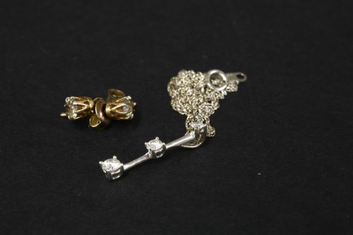 Lot 73 - A pair of gold single stone diamond stud earrings