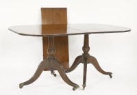 Lot 603 - A mahogany twin pillar dining table