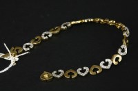 Lot 26 - A 9ct gold cubic zirconia set open heart link bracelet