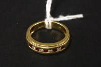 Lot 48 - An 18ct gold ruby and diamond half hoop ring