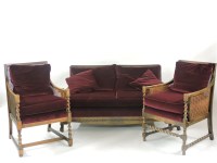 Lot 615 - A 1920s oak framed bergère three piece suite