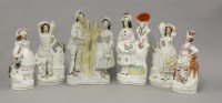Lot 1062 - (WH) A pair of Staffordshire figures of a lady and gentleman with dogs