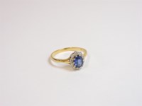 Lot 8 - An 18ct gold oval sapphire and diamond cluster ring