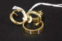 Lot 67 - A pair of gold coiled hoop earrings