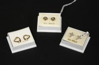 Lot 10 - A pair of 9ct two colour gold single stone diamond stud earrings
