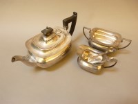 Lot 169 - A silver three piece teaset and sugar tongs