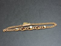 Lot 80 - An Edwardian gold graduated curb chain bracelet