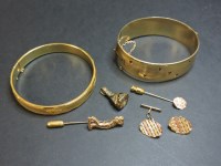 Lot 91 - A rolled gold hinged bangle