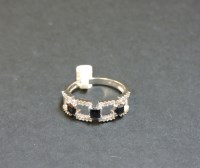 Lot 9 - A 9ct white gold sapphire and diamond half hoop ring