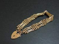 Lot 49 - An Edwardian four row gold gate bracelet