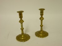 Lot 1279 - A pair of 18th century brass candlesticks