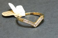 Lot 7 - A 9ct gold diamond set half wishbone ring