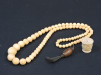 Lot 99 - A single row graduated ivory bead necklace