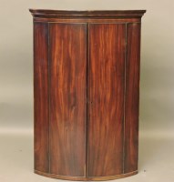 Lot 652 - A George III strung mahogany bow fronted hanging corner cabinet