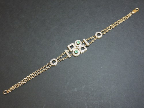 Lot 33 - An emerald and diamond gold bracelet