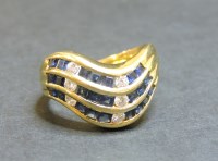 Lot 55 - A three row sapphire and diamond gold wave ring