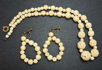 Lot 66 - A row of graduated carved ivory beads