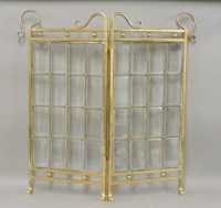 Lot 569 - An Art Nouveau brass framed single fold fire screen