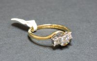 Lot 1 - A 9ct gold three stone princess cut diamond crossover ring