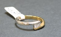 Lot 3 - A 9ct yellow and white gold two stone princess cut diamond crossover ring
