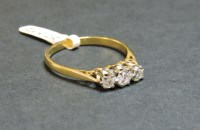 Lot 6 - An 18ct gold three stone diamond ring