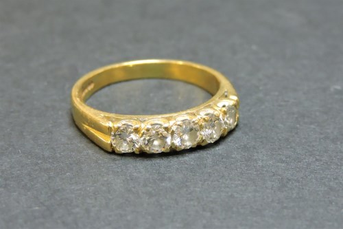Lot 8 - An 18ct gold five stone diamond half hoop ring