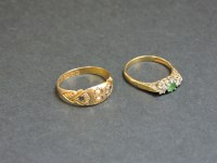 Lot 24 - A 9ct gold three stone emerald and diamond ring