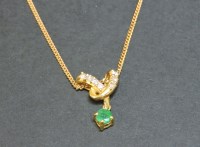 Lot 32 - An 18ct gold emerald and diamond pendant
