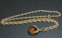 Lot 36 - A 9ct gold claw pendant