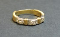Lot 58 - A two colour gold diamond set half eternity ring