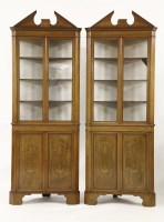 Lot 501 - A pair of Edwardian mahogany free-standing corner cupboards