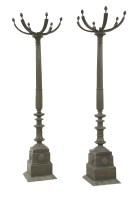 Lot 630 - A pair of bronze column uplighters
each with a square base and a fluted tapering column