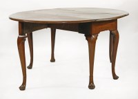 Lot 562 - A George II mahogany oval drop-leaf table