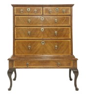 Lot 567 - A walnut chest on stand