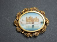 Lot 19 - An Indian gilt metal hand painted miniature on ivory brooch