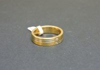 Lot 44 - An 18ct yellow and white gold satin finished band ring
