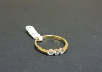 Lot 48 - An 18ct yellow gold three stone diamond ring