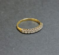 Lot 26 - An 18ct gold diamond set half eternity ring