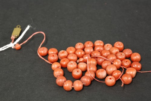 Lot 64 - A single row graduated coral bead necklace