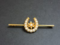 Lot 79 - A split pearl horseshoe bar brooch